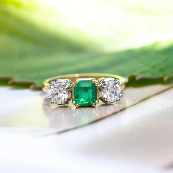 Newly-made in an antique style, it is an emerald and diamond ring. Using reclaimed stones.