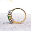 Newly-made in an antique style, it is an emerald and diamond ring. Using reclaimed stones.